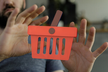 Image of a man rejecting a digital shopping cart, symbolizing online shopping refusal or hesitation.