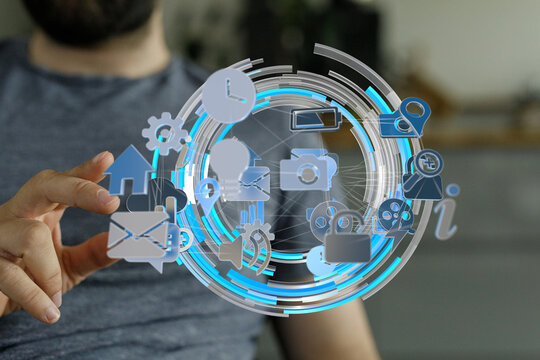 A man interacts with a digital interface displaying various social media and technology icons.  Modern technology concept.