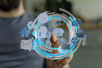 Person interacts with a futuristic interface showing various app icons.  Network, technology...