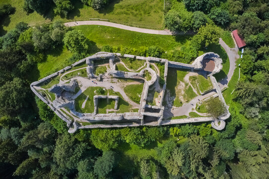 Aerial view of the ruins of Eisenberg Castle, a historic landmark amidst a sea of verdant trees under the summer sky, Eisenberg, Bavaria, Germany.