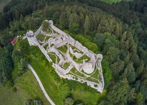 Aerial view of the stark white ruins of Eisenberg Castle stand majestically atop a hill, framed by a dense forest, Eisenberg, Bavaria, Germany.