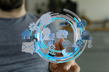 Person uses finger to interact with a futuristic digital interface displaying various application...