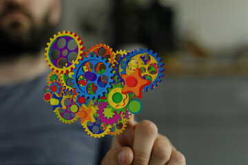 Image of colorful gears representing innovation, teamwork, and complex systems.