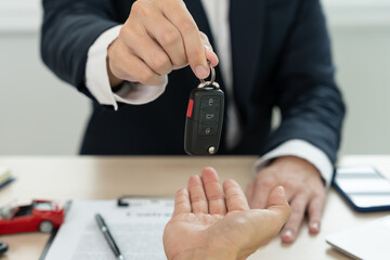 lease, rental car, sell, buy. Dealership manager send car keys to the new owner.  Sales, loan...