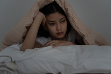 asian woman in bed late trying to sleep suffering insomnia, sleepless or scared in a nightmare,...