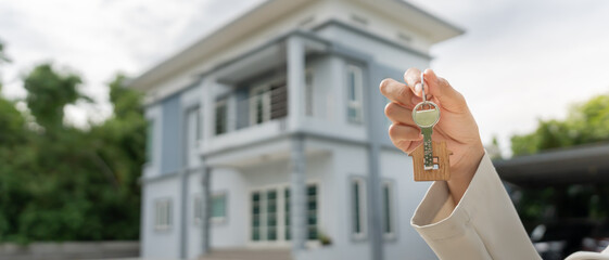 lease, rental and selling home. Real estate agent manager holding key for new owner.  rent house,...