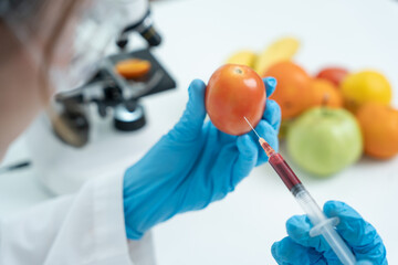 Scientist check chemical food residues in laboratory. Control experts inspect quality of fruit,...