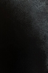 Textured black surface showcasing subtle variations in shade and depth for artistic purposes