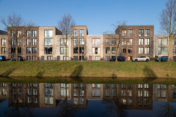 Modern colorful residential buildings along the water in the Vathorst district in Amersfoort.