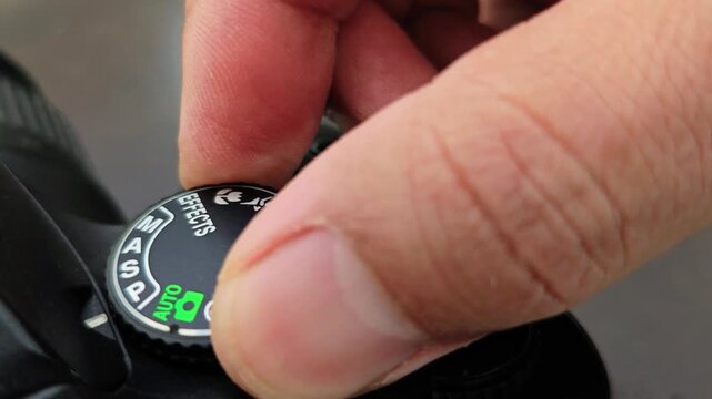 Camera Mode Dial Adjustment Switching from Auto to Manual Settings.