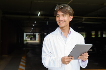 Young scientist student researcher wearing lab coat using tablet computer