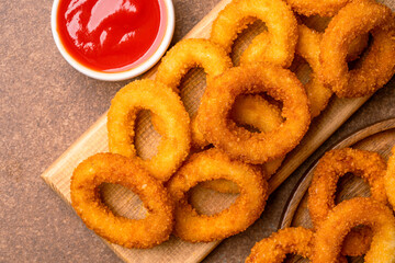 Fried onion rings on vintage brown  background