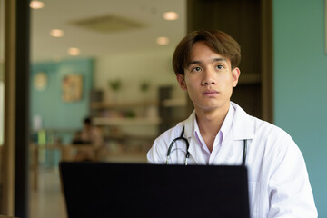 Doctor sitting and using laptop computer