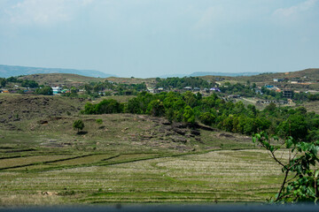 Rural village nestled in rolling hills and fields in Meghalaya. 