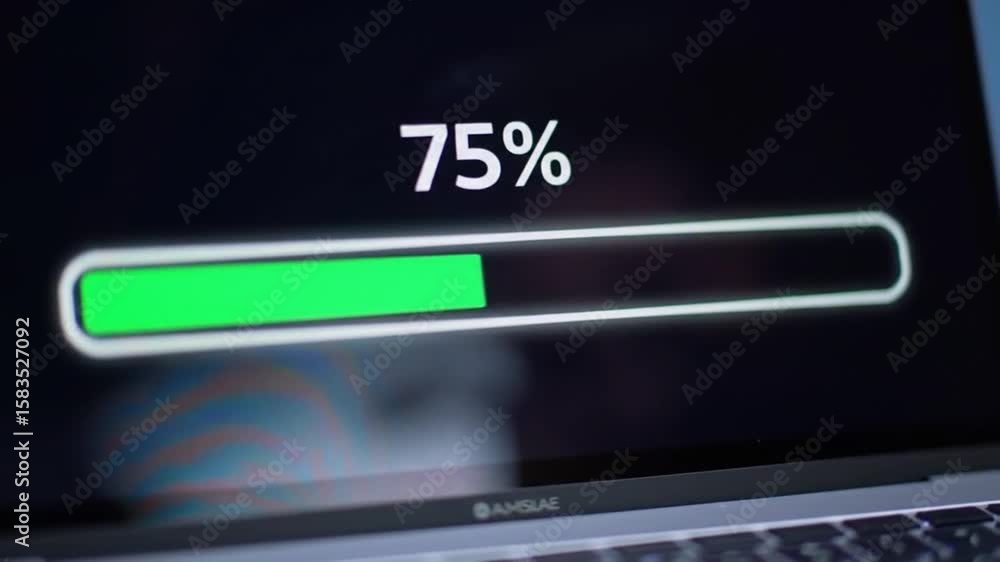 Poster laptop screen displaying green charging progress bar against dark background with visible keyboard a