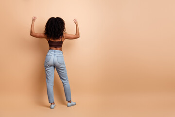 Stylish young woman showing confidence in a contemporary studio setting with a vibrant casual style...