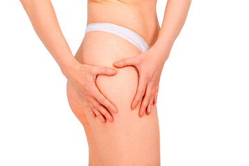 Woman showing thigh skin to check for cellulite. Woman examining herself after liposuction, thigh...