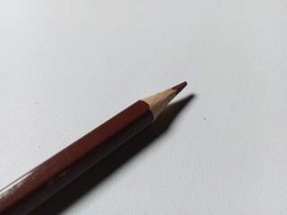 Brown colored pencil isolated on white background.