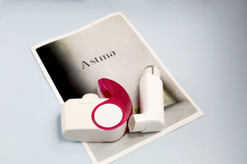 Asthma inhalers and a brochure with the inscription asthma. High quality photo
