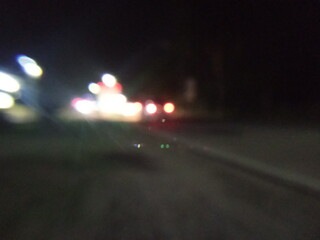 Defocused abstract background, vehicle lights at night.