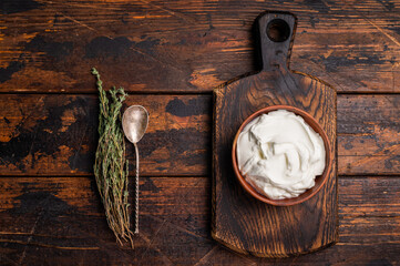 Dip sauce with Fresh Sour cream in a bowl. wooden background. top view