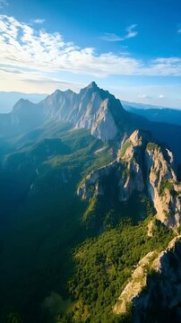 Majestic Aerial View of Rocky Mountain Peaks and Forest at Sunrise