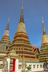 Fototapeta premium Beautiful spired chedis housing the ashes of royal persons at Wat Pho