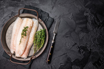 Raw Loin cod fish fillets ready for cooking whitefish in stell tray. black background. top view