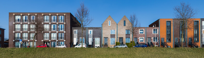 Modern colorful residential buildings along the water in the Vathorst district in Amersfoort.