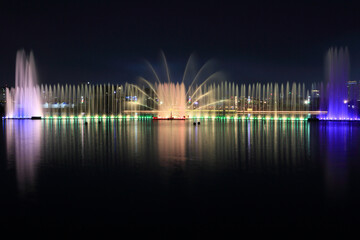 Fountain view at midnight park with colorful lights