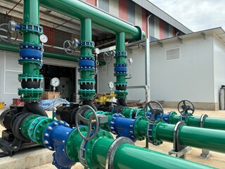 Industrial cooling tower system with metal piping, heat exchangers, and elevated pipe racks under...