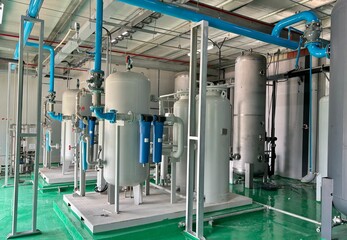  Industrial air compressor system and filtration tanks in a clean facility. Modern piping layout...
