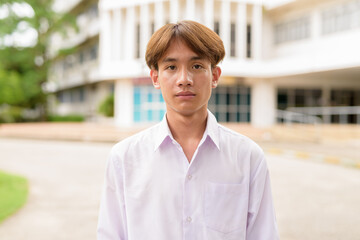 Non binary university student in college campus