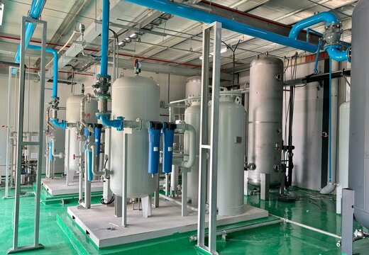  Industrial air compressor system and filtration tanks in a clean facility. Modern piping layout with pressure vessels, filters, and stainless steel components used in factory and utility infrastr