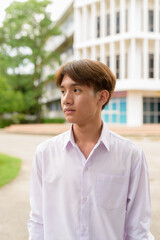 Non binary university student in college campus