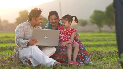 indian farmer family using laptop  - Powered by Adobe