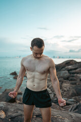 Athlete on rock showcases strength and nature challenge, Muscular athletic climber man at mountain peak radiates fitness and rugged success