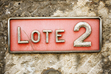 A weathered metal sign reading 