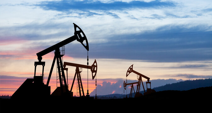 The change in oil prices caused by the war. Oil price cap concept. Oil drilling derricks at desert oilfield. Crude oil production from the ground. Petroleum production.