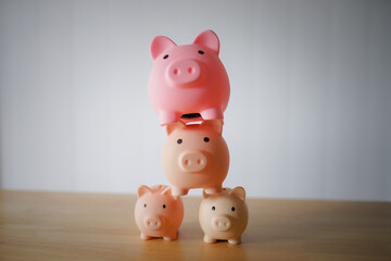 Piggy bank with money on white and wooden backgrounds representing savings and finance