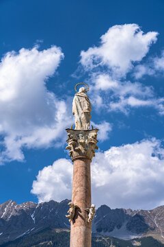 Close view of St. Anne's Column on Maria Theresien Street in center of Innsbruck with Nordkette mountain in background in spring, Tyrol, Austria