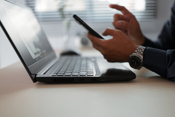 The hand of Asian woman holding a mobile phone and press, slide or touch screen for searching about...