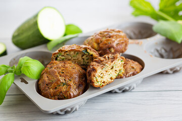 Vegetarian zucchini muffins in a bright presentation on a light wooden table