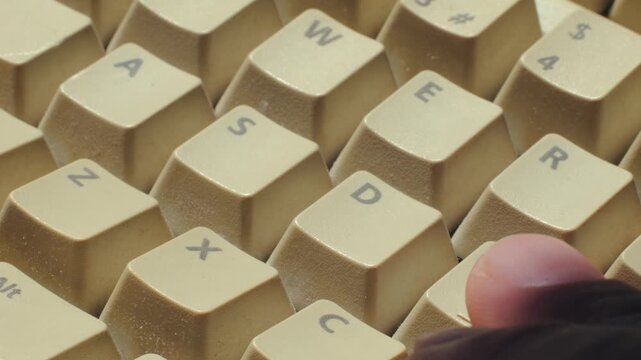 Man working and gaming on retro computer PC, IT engineer with vintage computer at home, using old fashion technology, close up of retro setup. 