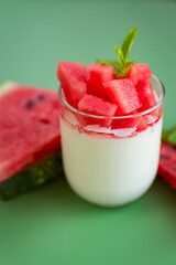 Healthy snack: watermelon pieces and sweet yogurt close-up