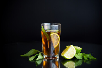 Natural fermented drink with mint and citrus on a black background