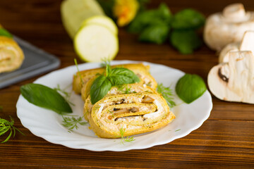 zucchini roll cooked with cheese filling and mushrooms, on light wooden table