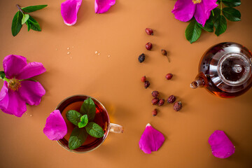 Aesthetic serving of tea with rosehip, petals and mint greens