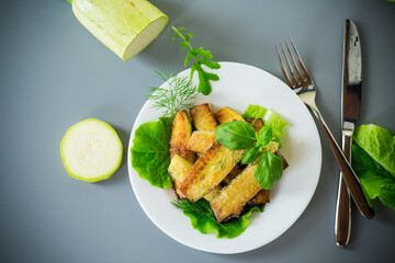 Vegetable appetizer of zucchini and dill on a gray background
