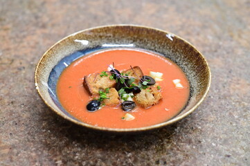 Tomato gazpacho soup with olives, garlic and croutons